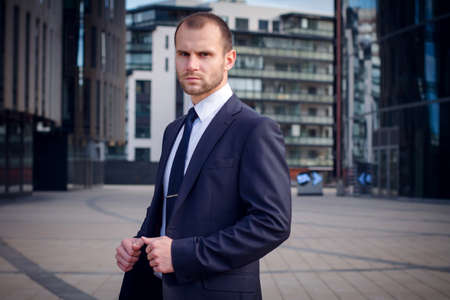 Portrait of serious businessman on a background of office building
