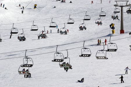 Chairlift at crowded spanish ski resort 