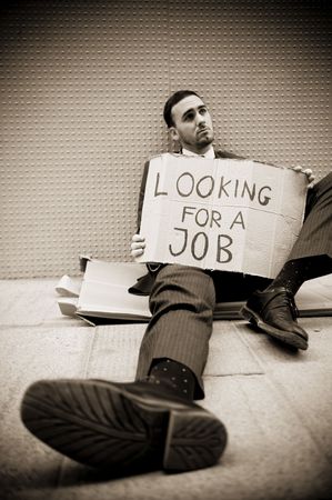 Young businessman holding sign Looking for a jobの写真素材