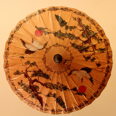 Chinese traditional oil paper umbrella, with a crane and ancient pine drawing on itのeditorial素材