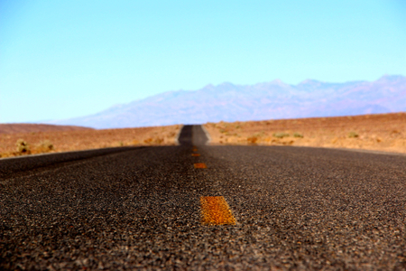 Road in the Death Valley National Park with colorful sky background, California.の写真素材