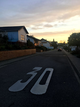 speed limit 30 painted on asphalt in a normal German town.