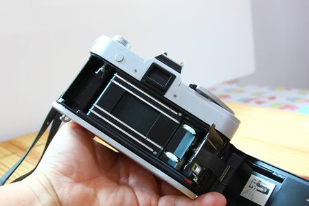 manual camera film with color film on wood floor,grain in photo is still a charm of the olden days technology.の写真素材