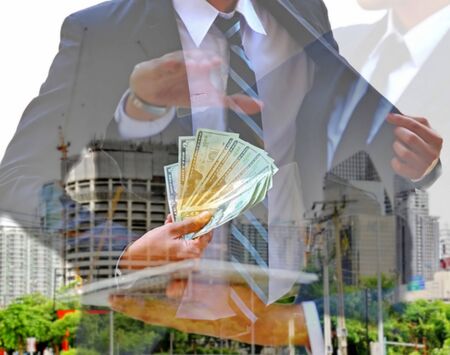 business man and building designer in suit  with construction building background. investor take...