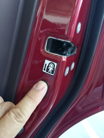 the warning safety sticker.the sticker guide tell  man pull down the button to protect children open door from car inside .の写真素材