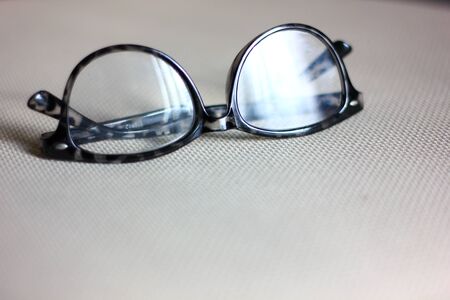 black spectacles on fabric chairの写真素材