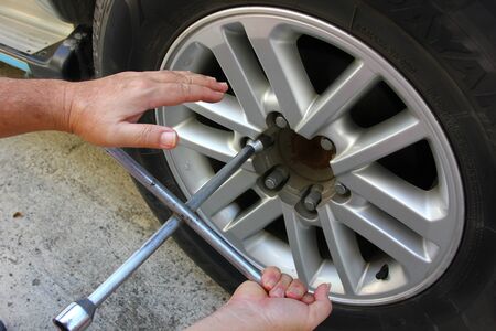 the owner car is using tool box remove the wheel .の写真素材
