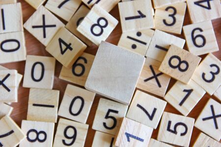 top view wood cube with the number on little woods on wood floor.