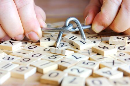 close up hand holding the magic nails with number on little woods background. business man sloving...