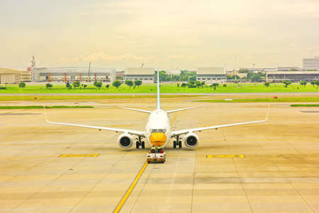 BANGKOK,THAILAND-5 SEPTEMBER;2019;ground crew on pushback take airplane to runway or taxiway at DON...
