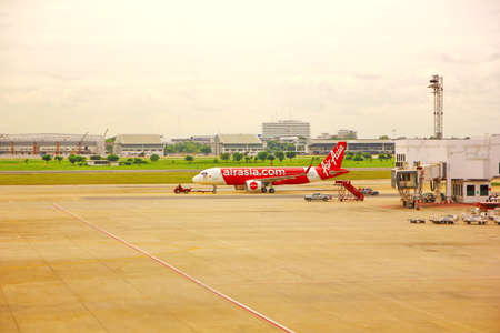 BANGKOK,THAILAND-5 SEPTEMBER;2019:Air Asia low cost airline loading cargo and luggage before departure.air staff working at apron  DON MUANG INTERNATIONAL AIRPORT in cloudy day.のeditorial素材