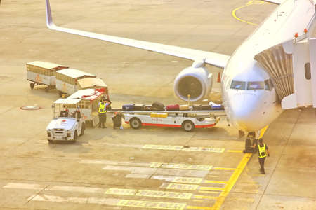 BANGKOK,THAILAND-5 SEPTEMBER;2019:Air Asia low cost airline loading cargo and luggage before departure.air staff working at apron  DON MUANG INTERNATIONAL AIRPORT in cloudy day.のeditorial素材