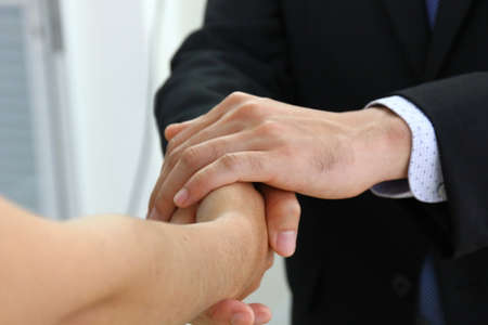 close up business man handshake with new partner. the manager handshake with the new worker  to join in workの写真素材