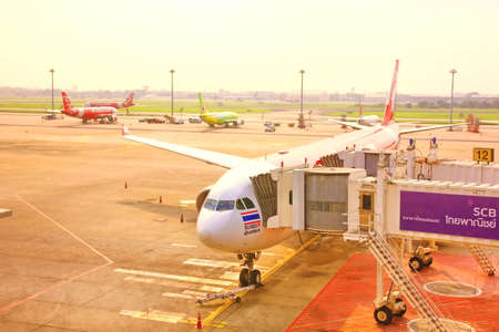 BANGKOK,THAILAND- 4 APRIL;2018:Plane dock to disembarkation bridge in airport in cloudy dayのeditorial素材