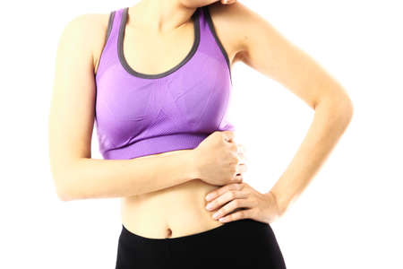 Asian woman in gym cloth is waist pain .young woman in sport wear squeeze her hand on waist pain.isolate on white backgroundの写真素材