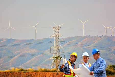 the electrical engineer group are inspection  the power transmission system of wind turbine to high voltage poleの写真素材