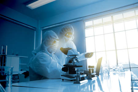 doctors working in virus lab. doctor using microscope check for viruses in laboratoryの写真素材