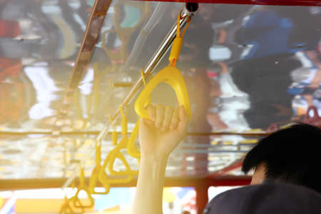 hte passenger hold hanger on busの写真素材