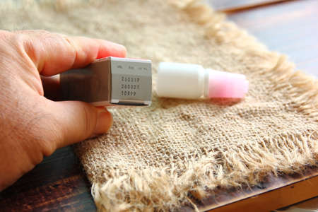 man is checking the  manufecture date and expiration date before usedの写真素材