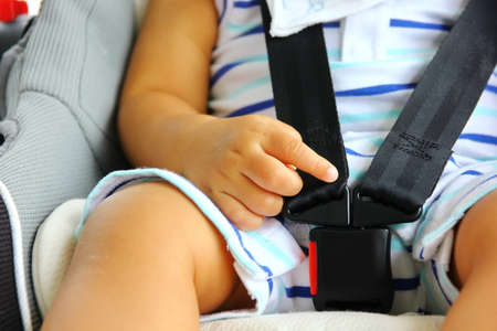close up safety lock of carseat  . Asian baby  in carseat safety on the way