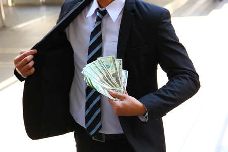 businessman showing dollars in handの写真素材