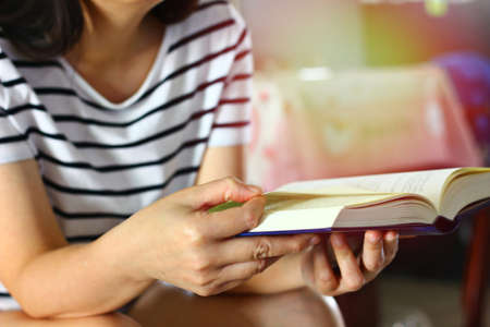 woman reading novel or book at home in relax moment