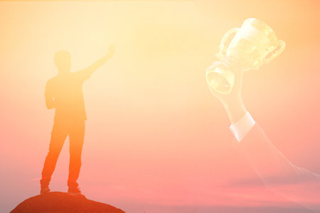 man stand on the rock point his hand at the golden trophy in business hand target of worker , worker...