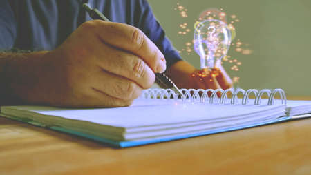 man is recording ideas for solving problemsの写真素材