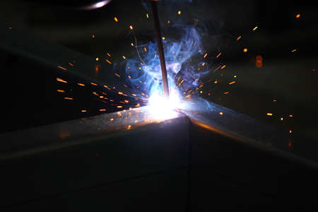 close up welding steel light sparks smoke isolate on back