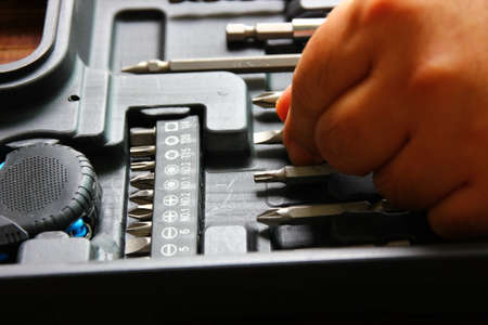 close up hand catch one of screwdriver set in diy boxの写真素材