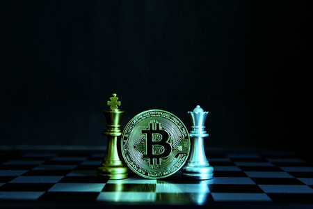 bitcoin between golden king chess silver queen chess on board isolate black background