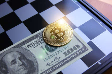 bitcoin on American dollar bank note with chess board
