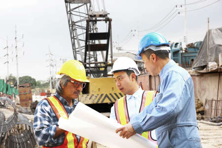 staff engineer bored pile team planning work in concturction site. group of engineers consulting...