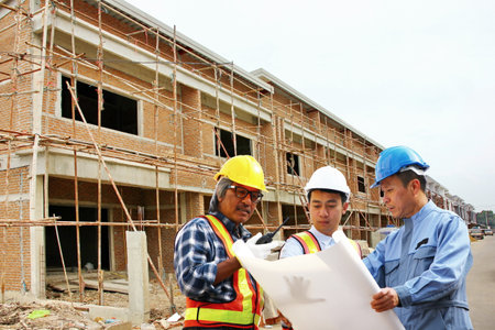 staff engineers are brainstorming solutions between working in construction siteの写真素材