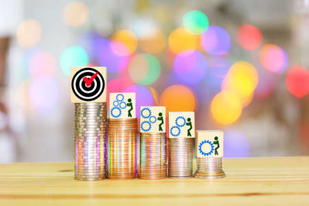 illustration people gears icon on wood cube on top of coin stack with bokeh multicolor background , idea people working conceptの写真素材
