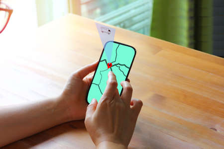Asian woman using application on mobile phone following her parcel between delivery at home. Online...