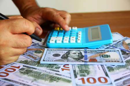 American dollar with financer working with calculator