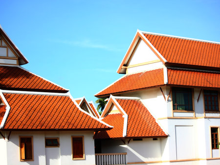 Thai resident using roof tiles goemetric shape exterior design retroThai style against blue skyの写真素材
