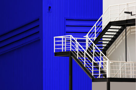 steel stairs install outside building in conteiner yard distribution center .  blue  corrugated metal wall with ventilation vents of warehouse factoryの写真素材
