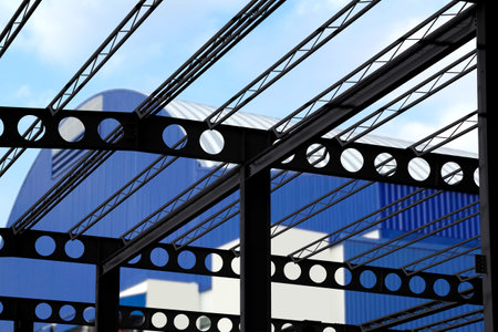 black steel structure of warehouse in front of  corrugated metal warehouse  distribution centerの写真素材