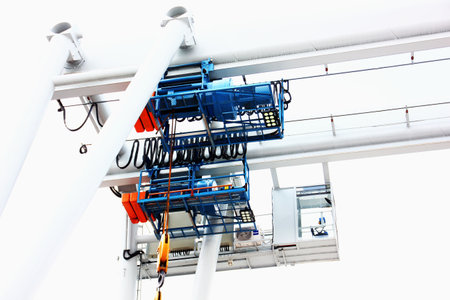 close up low angled shot outdoor two hoists moter set on beam isolate on whiteの写真素材