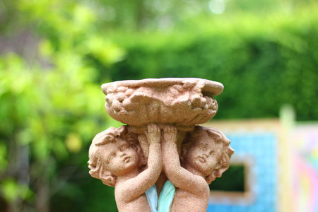 close up  sculpture of a boy and girl little angle in a loving mood decoration in gardenの写真素材