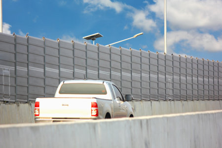 soundproof wall install on concrete bridge in community . cement  soundproof barrier reduce traffic noise pollution vehiclesの写真素材