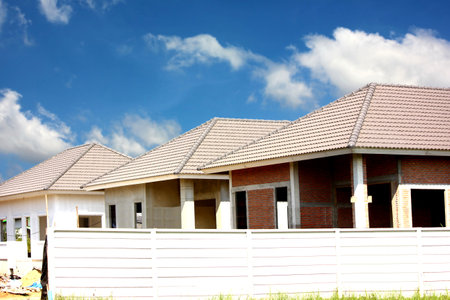 building under construction roof design triangle shape on blue sky white cloud shapeの写真素材