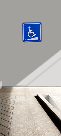 warning sign on wheelchair install on gray wall and ramp, universal design conceptの写真素材