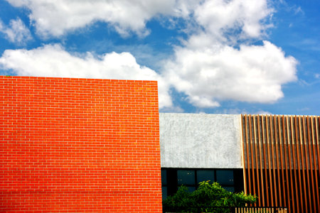 Red brick wall and blue sky with white clouds, perspective view.の写真素材