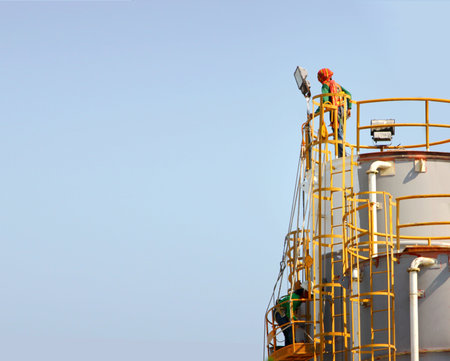 the workers renovated raw materials industry supply  tank making new color on tank