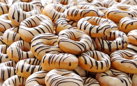 many chocolate donuts to stack for partyの写真素材