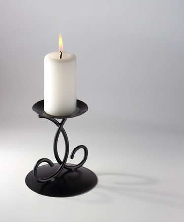 candle and candlestick with fade shadow on white background の写真素材