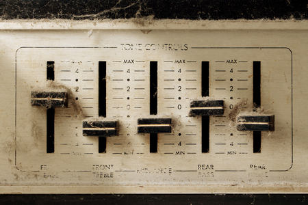 tone controls of old stereo receiver with dust and cobwebの写真素材